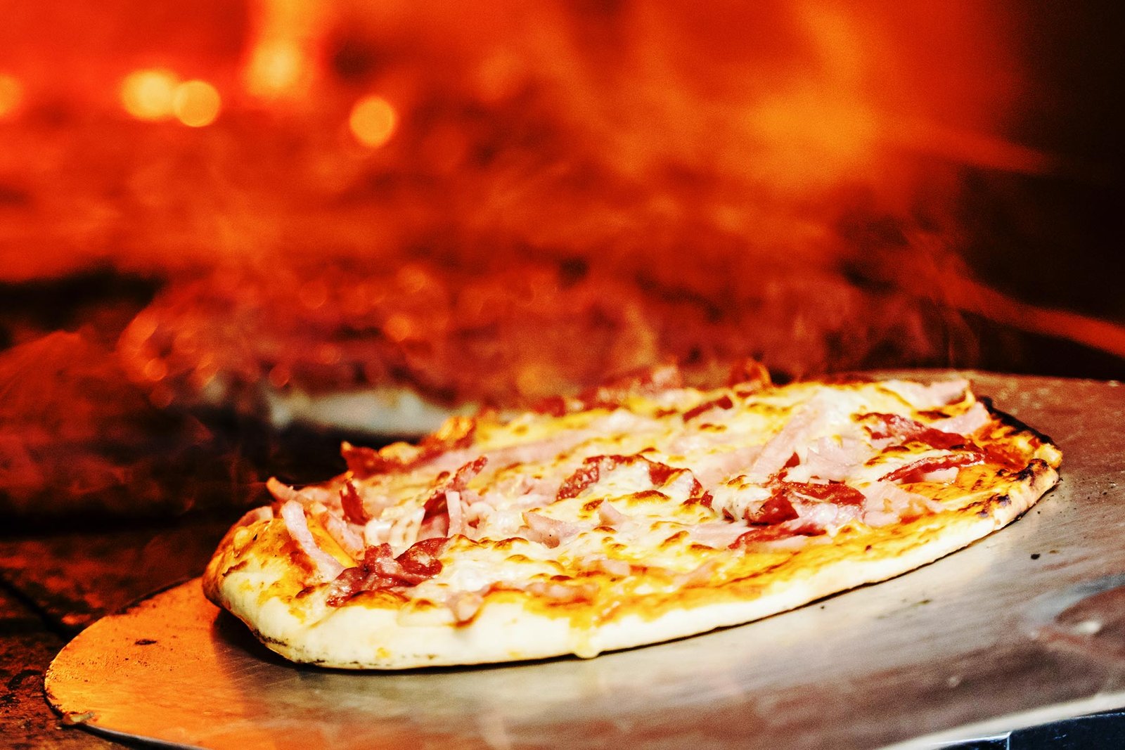 Fresh wood-fired pizza with basil and roasted toppings